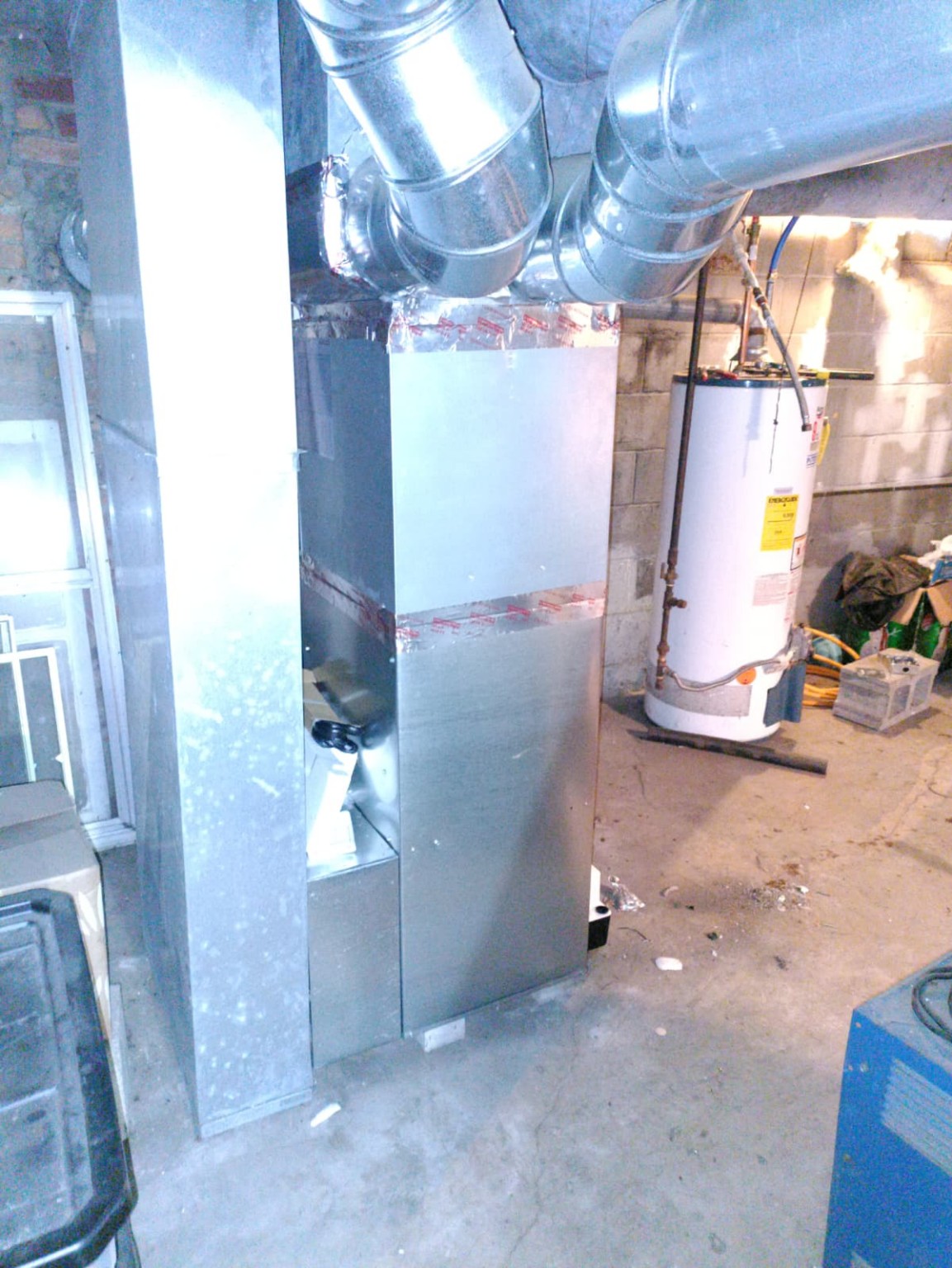 New basement HVAC air handler with sealed galvanized ductwork and return drop