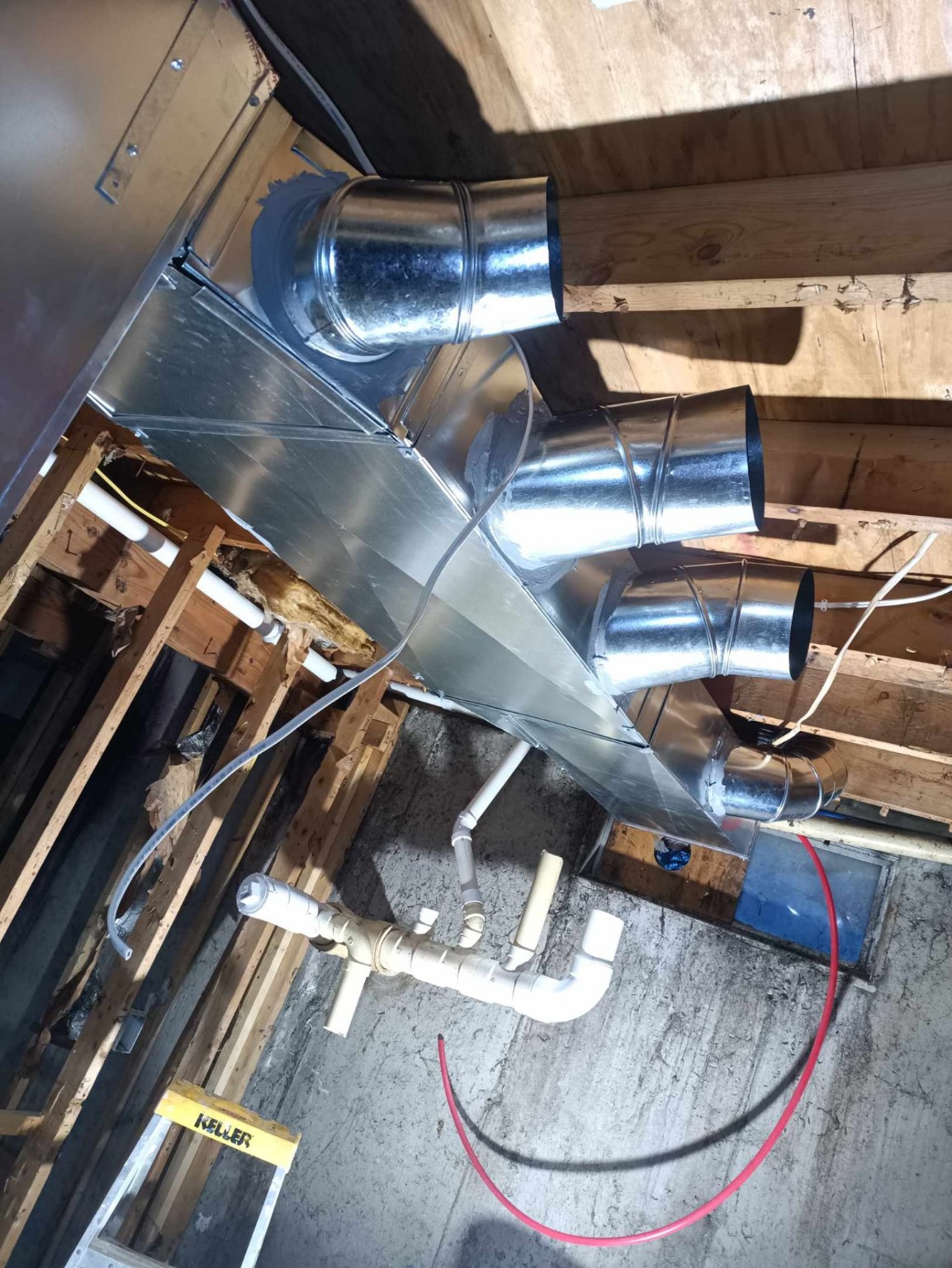 Galvanized plenum with round takeoffs, mastic seals, and PVC condensate piping